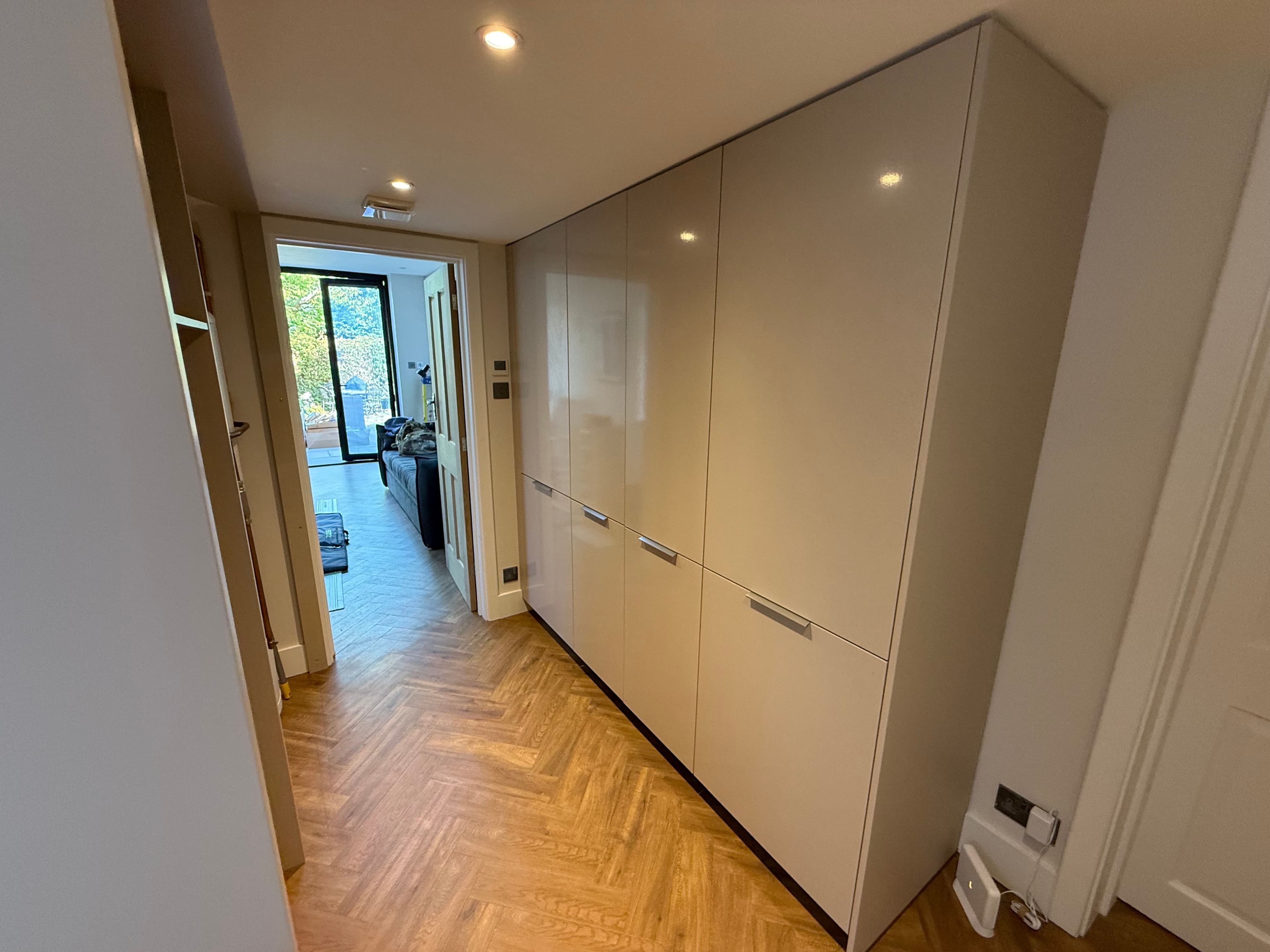 Bespoke Utility Room - Professional utility room installation featuring stacked appliance housing and custom storage solutions.