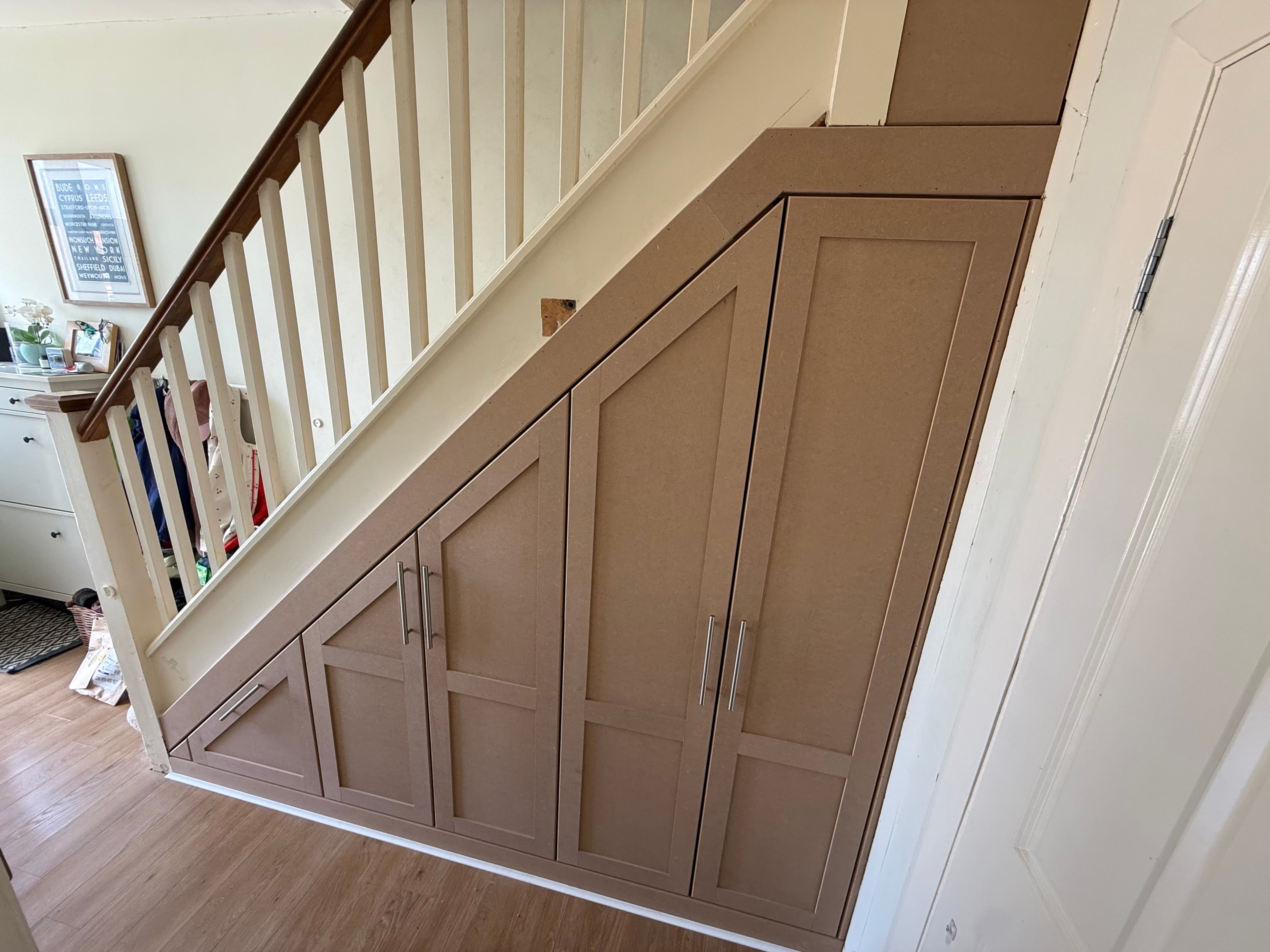 Under Stairs Storage (Morden) by Devlin Carpentry in London & Surrey - Bespoke space-saving storage solution integrated into an existing staircase.